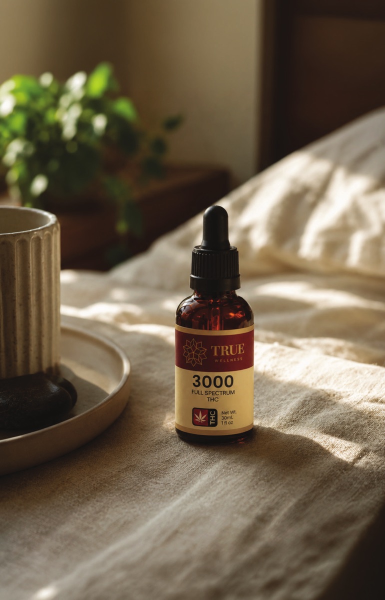 True Wellness oil on a bedside table
